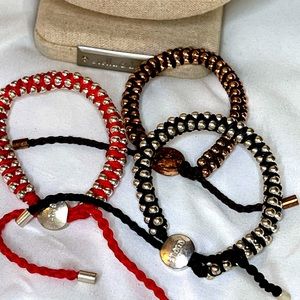 3 bracelets good condition pull string  red black and rose gold